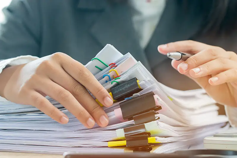 Person working on documents on the table