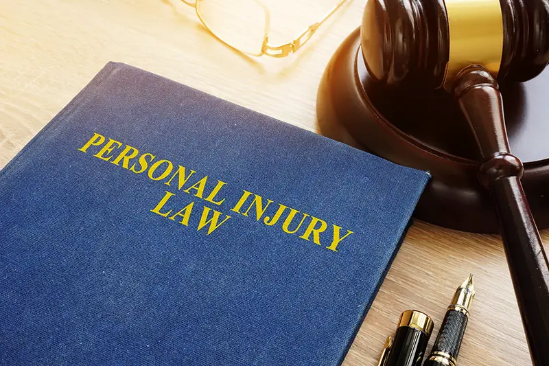 Personal injury law on desk and gavel
