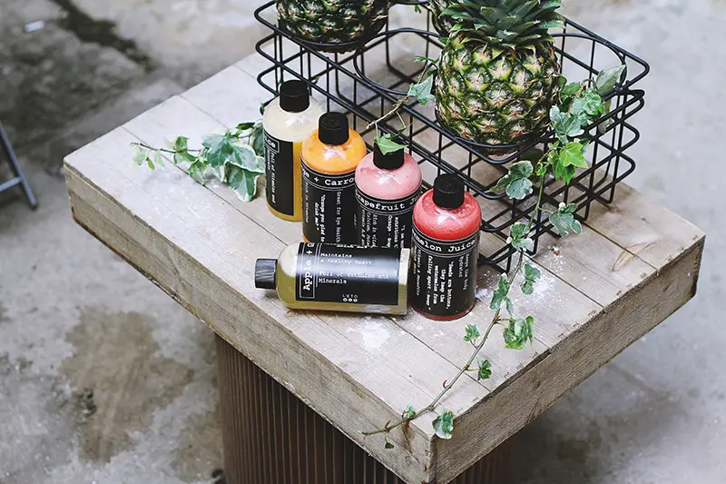 Five assorted bottles on brown table