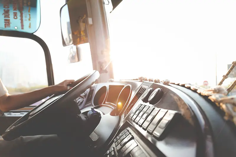 hands on the whell in the cab of commercial truck