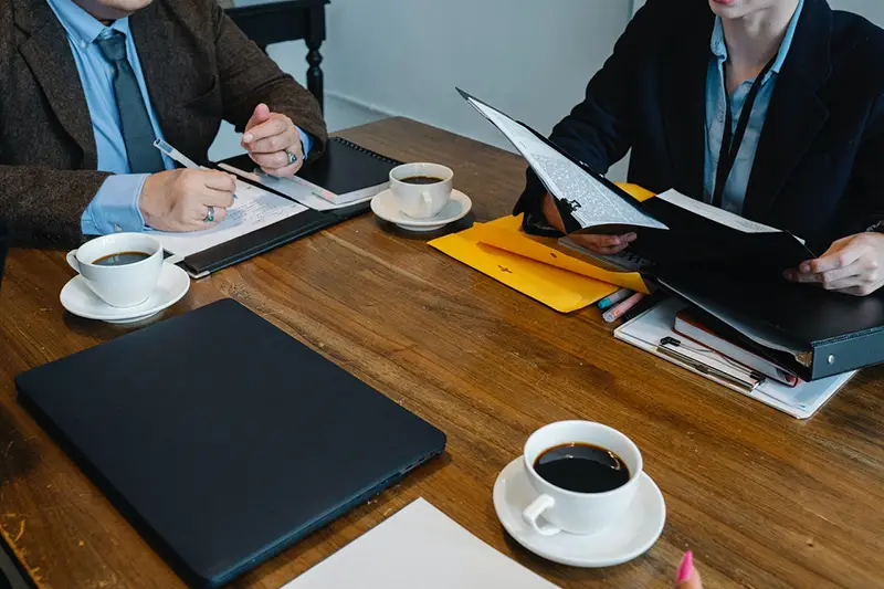 cropped image colleagues discussing business project in workspace