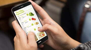 online shopping concept: girl using a digital generated phone with online supermarket on the screen. Online grocery shopping