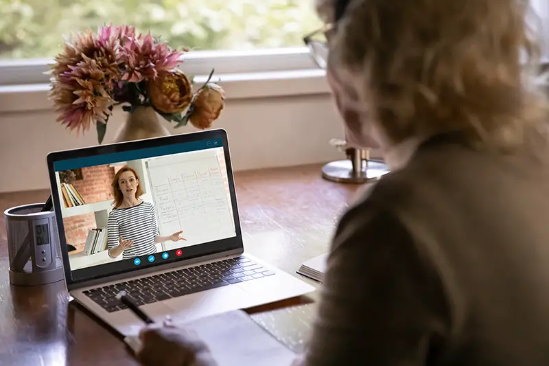 Rear close view of woman watching webinar