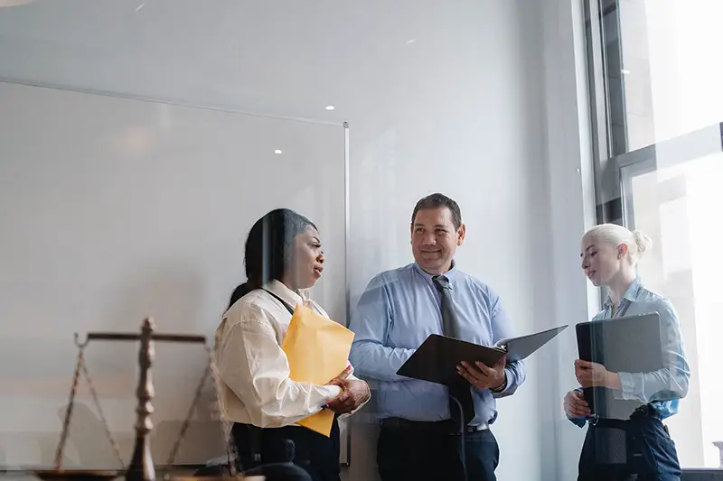 diverse colleagues talking about work in legal office