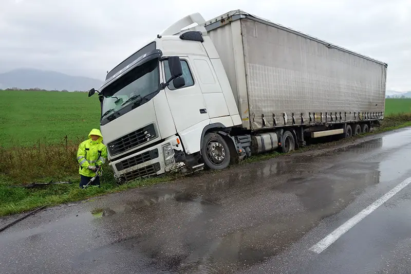 White truck in out of balance on the side of road