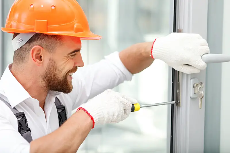 Young builder installing lock door