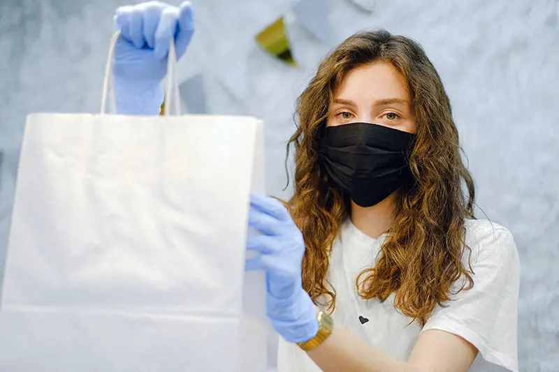 Woman with facemask and latex gloves