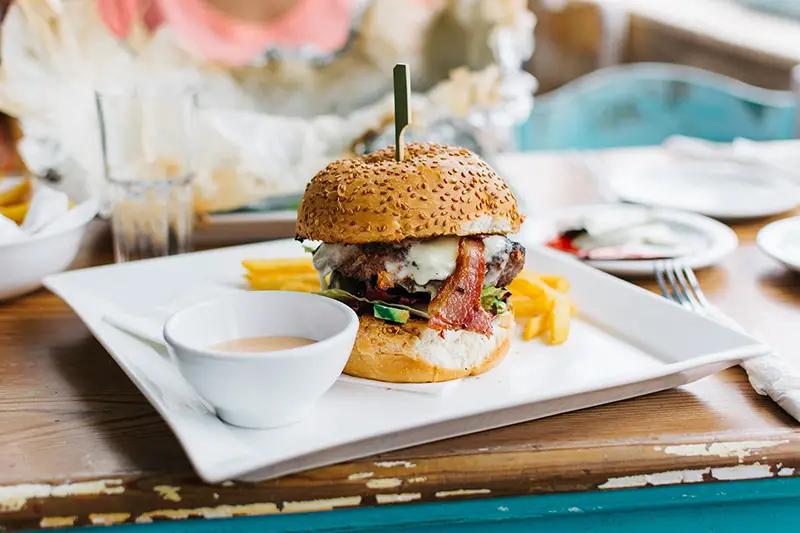 Burger with cheese on the white plate