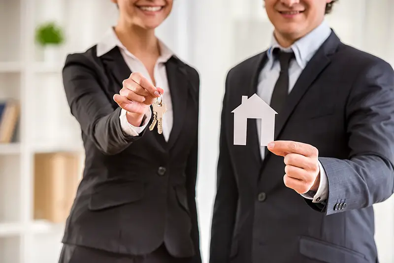Man and woman real estate agent in black suit