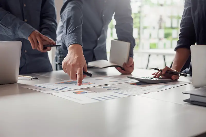 Group of business people meeting together Pointing to the graph assess business profits