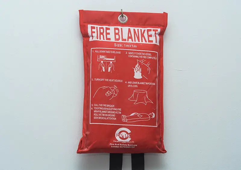 Fire blanket mounted in the wall in the house