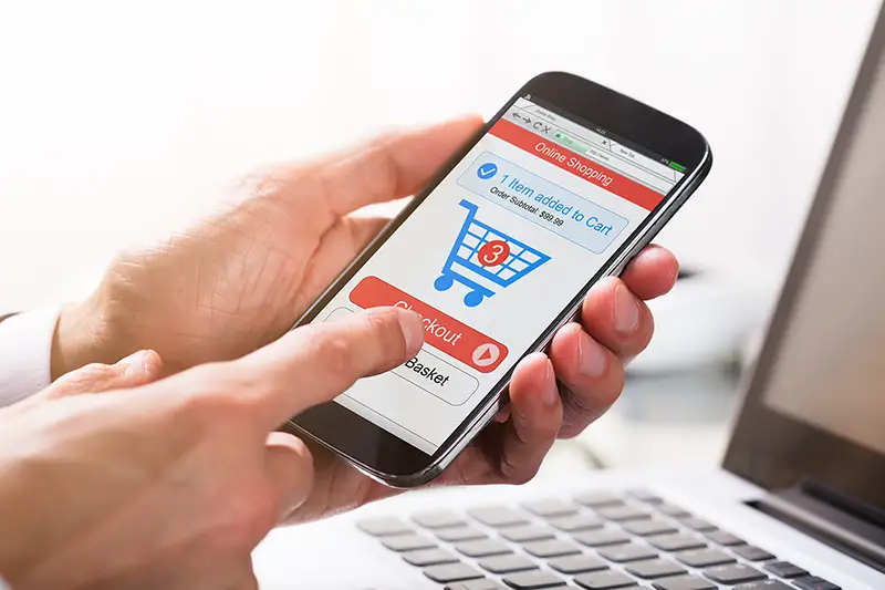 Close-up Of A Businessperson's Hand Clicking On Checkout Option While Shopping On Mobile Phone – ecommerce payment