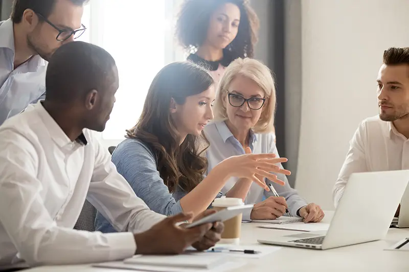 Young female mentor leader coach teaching employees group