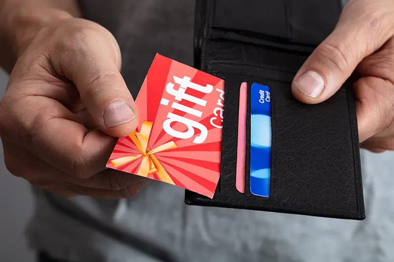 Human Hand Removing Gift Card From Wallet