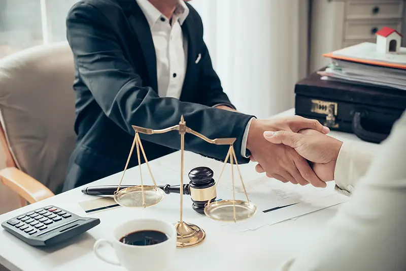 Businessman shaking hands with his partner lawyers discussing a contract agreement