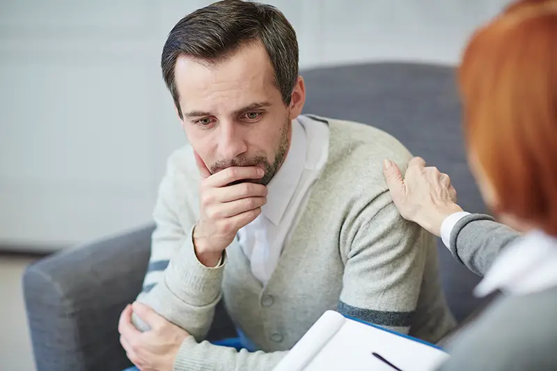 Unhappy man consulting to a psychologist