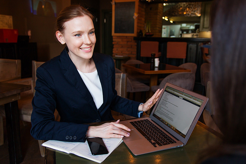 Happy business woman holding her laptop