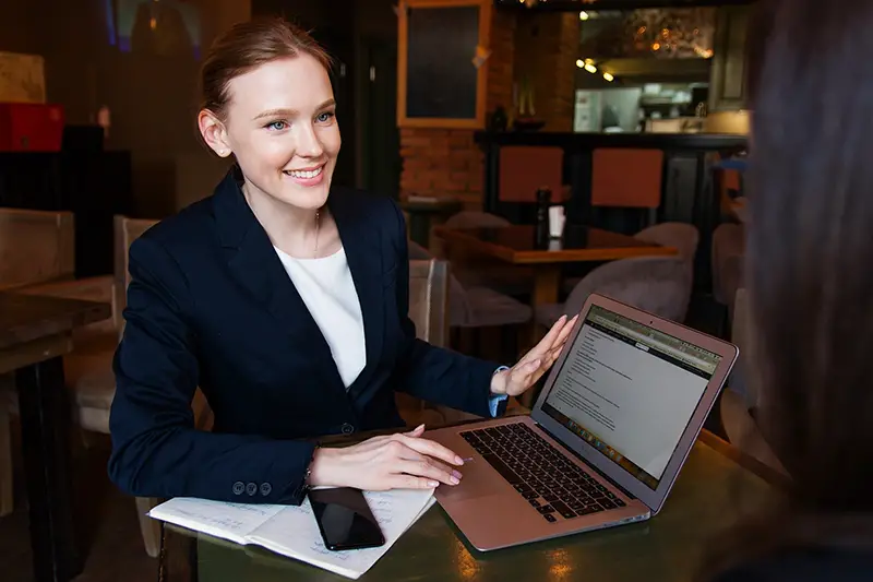 Happy business woman holding her laptop