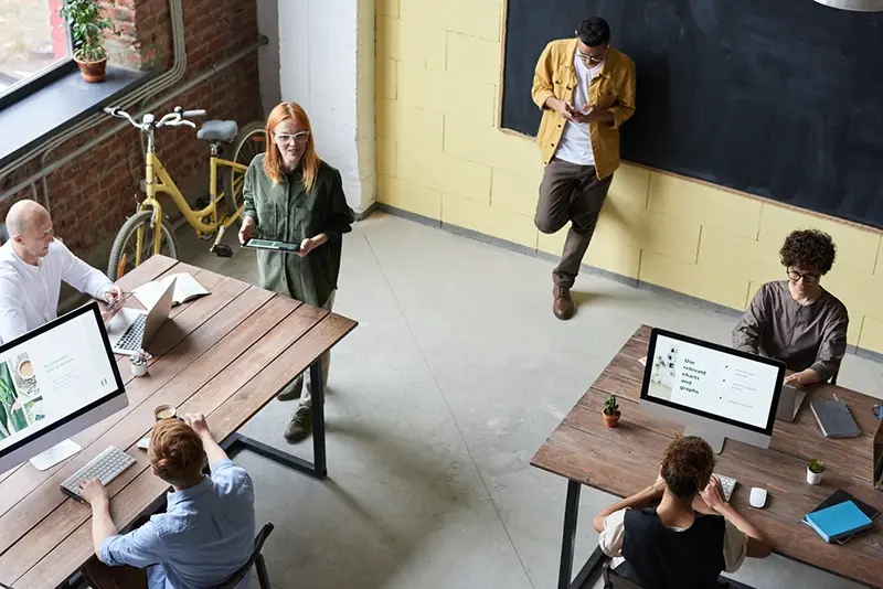 People working in a brown wooden table