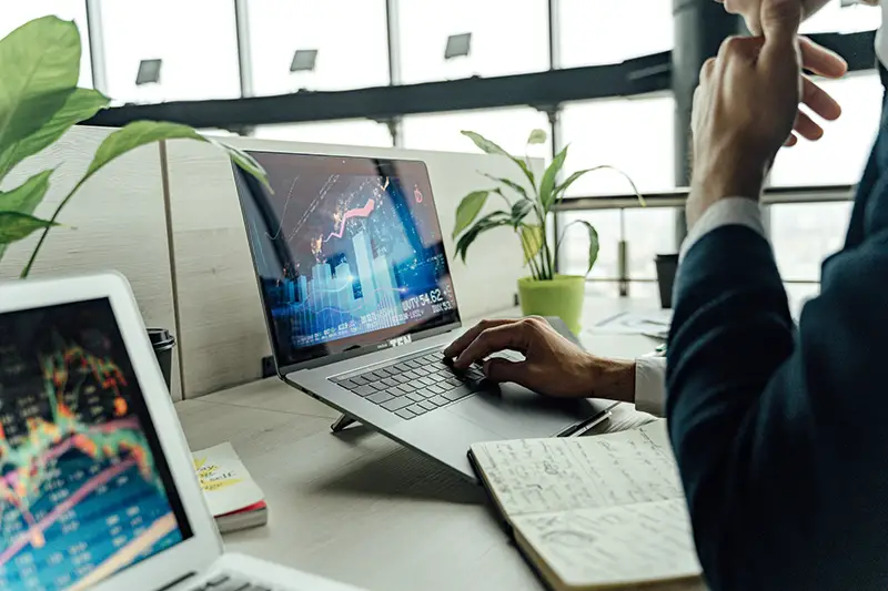 Person using MacBook Pro on the table