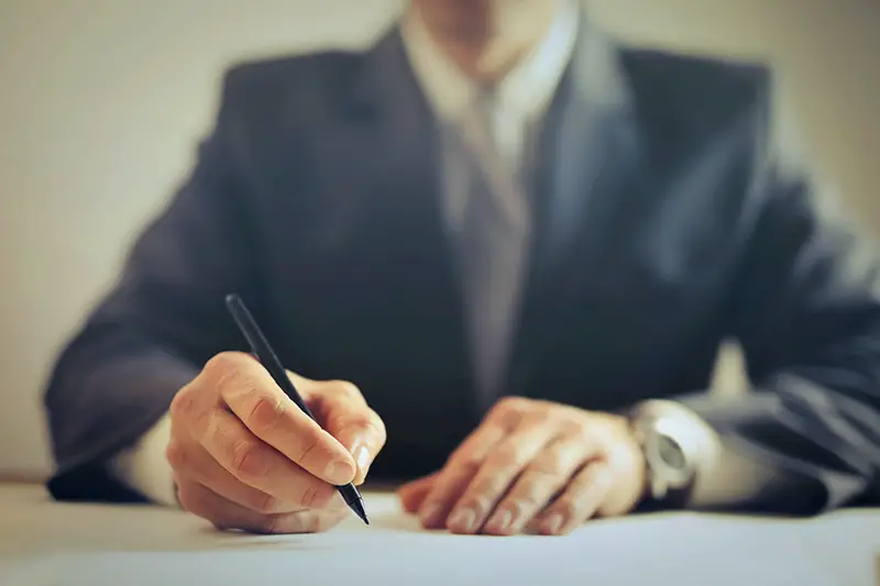 Businessman signing contract in the office