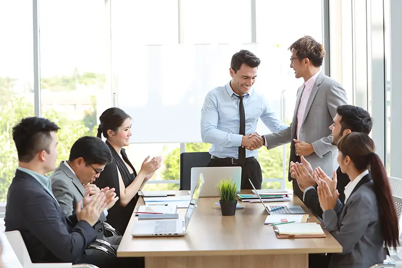 Caucasian businessman showing success business profit graph from white board in meeting