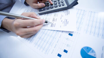 woman hand with pen and business report