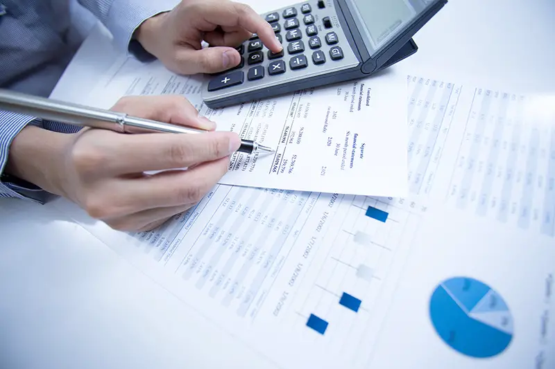 woman hand with pen and business report