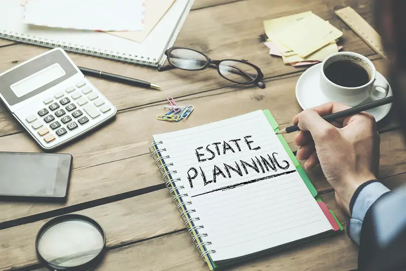 man written estate planning text on page and stationary on table