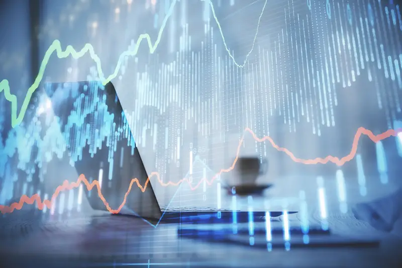 Double exposure of graph and financial info and work space with computer background. Concept of international online trading.