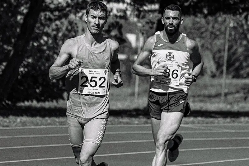 Muscular male athletes running during track and field