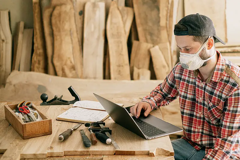 Man using laptop on the top of wooden table