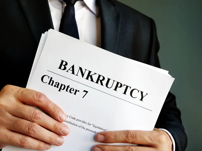 Bankruptcy Chapter 7 documents in the hands.