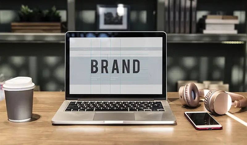 Labtop on desk showing the word brand