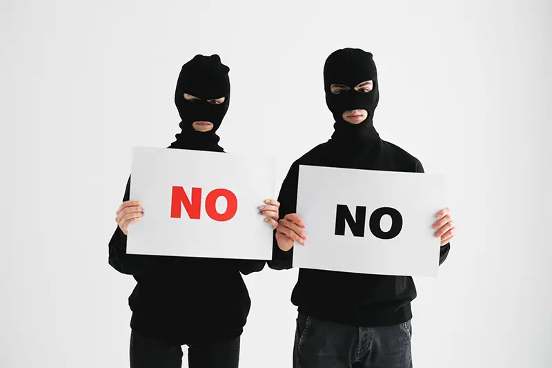 Man in black long sleeve shirt holding white printer paper