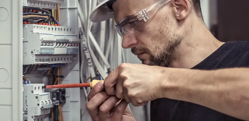 a male electrician - electrical contractor at work