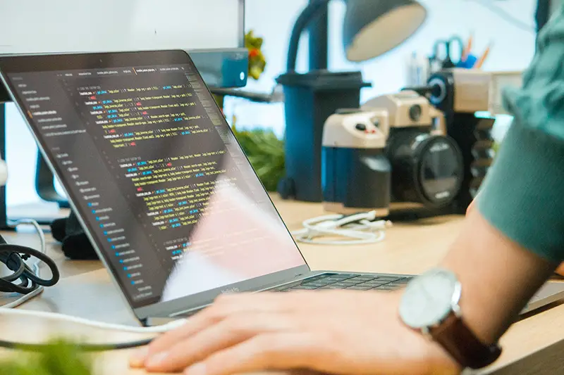 silver greay laptop showing programming code