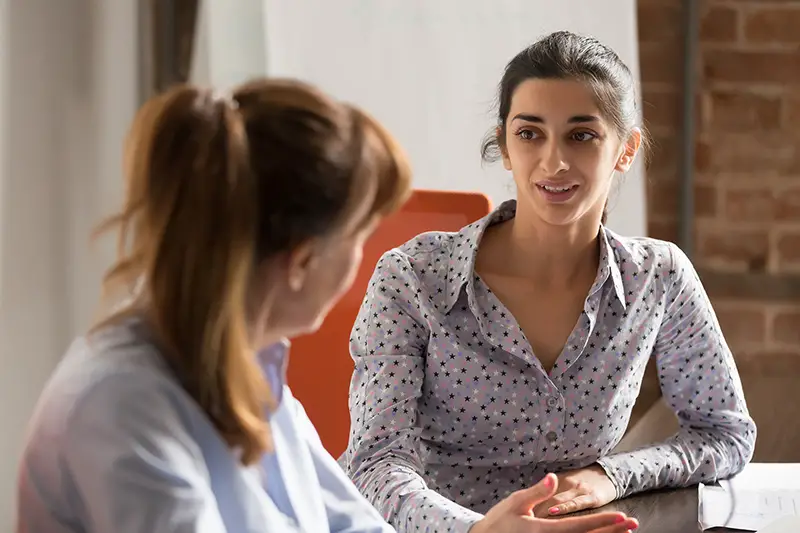 young professional hindu woman manager consulting client