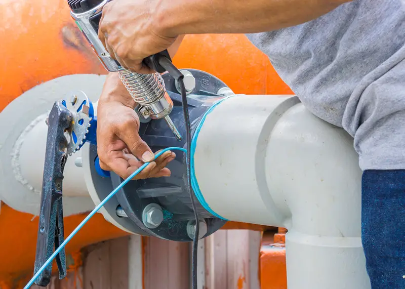 Plumber is welding off the leak of PVC pipe.