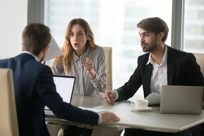 Disgruntled workers or dissatisfied angry clients customers arguing having complaint dispute conflict with lawyer about bad contract demanding fraud compensation negotiating at work office meeting