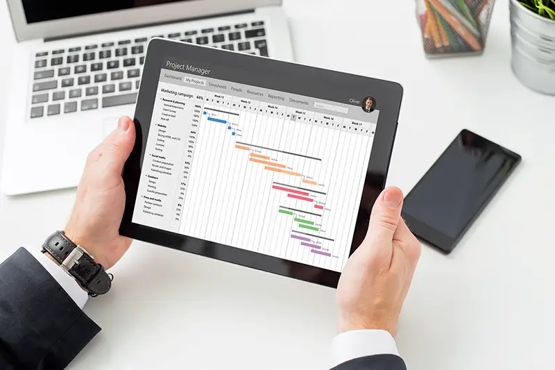 Businessman looking at Gantt chart on tablet computer