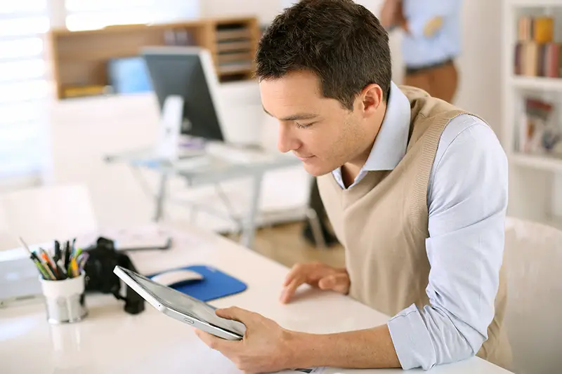 Handsome guy working with tablet in office