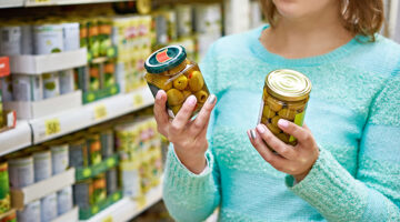 Woman reading the product label in the grocery