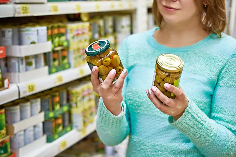 Woman reading the product label in the grocery