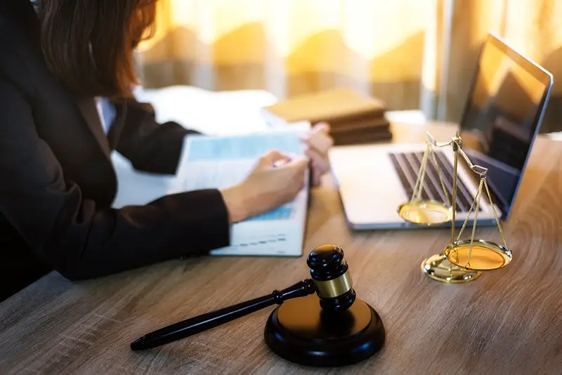 Lawyer business women working and writting in notebook on desk at office