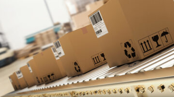 Packed products on production line in cardboard boxes in warehouse