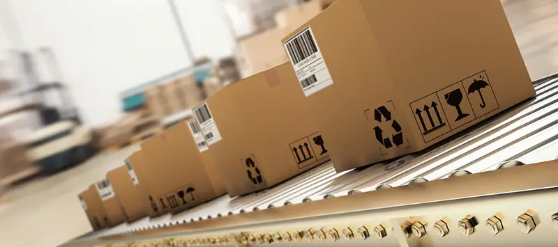 Packed products on production line in cardboard boxes in warehouse