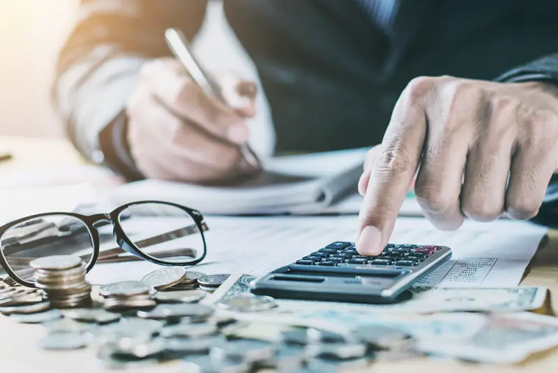 Accountant working while using calculator