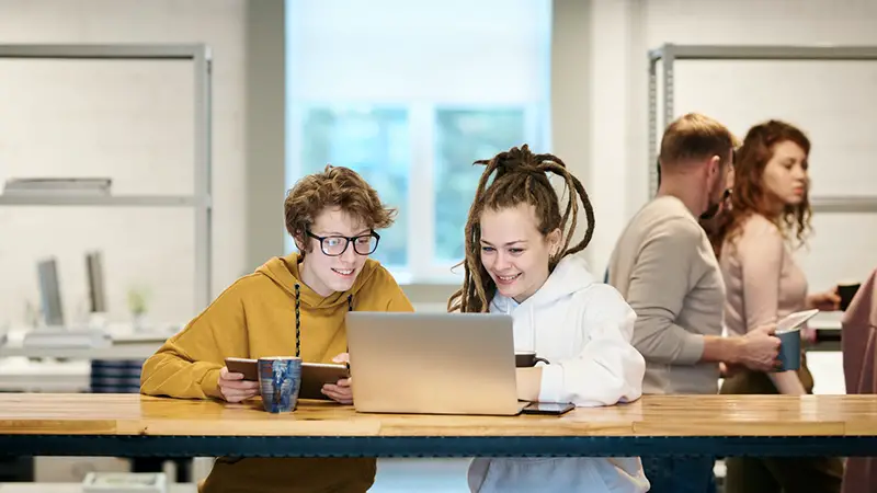 Two girls looking on the laptop