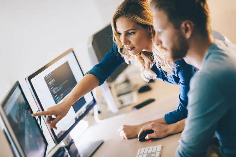 Man and woman working in front of computer